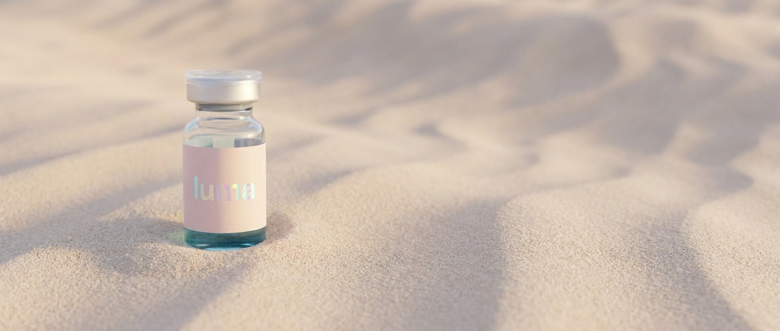 A peptide vial on a wide sweep of pale sand